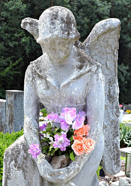 istock statue of an angel holding flowers 497186761