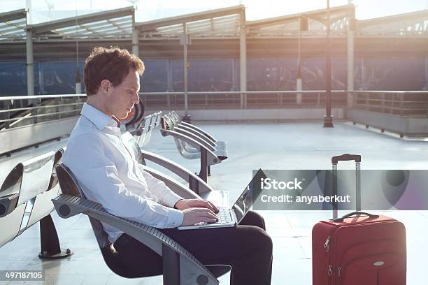 Businessman Sitting At Airport With Laptop Stock Photo - Download Image Now - Working, Portability, Business Travel