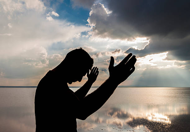 istock Silhouette of a praying man 497187145