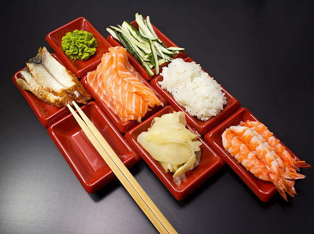 istock Ingredients for sushi: sliced salmon cucumber rice wasabi and ginger 497187191