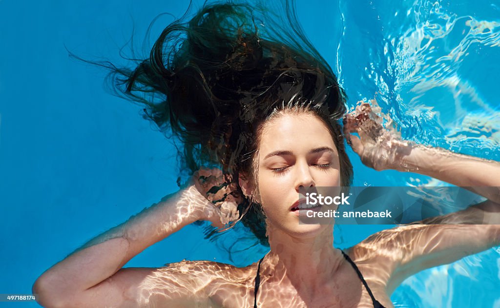 Summer's here, time to go with the flow Shot of a young woman in a swimming poolhttp://195.154.178.81/DATA/i_collage/pu/shoots/805938.jpg 2015 Stock Photo