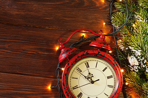 istock Christmas alarm clock, tree branch and lights 497189706