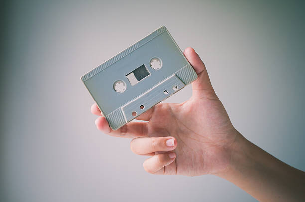istock Hand offer old retro cassette tape. 497190356