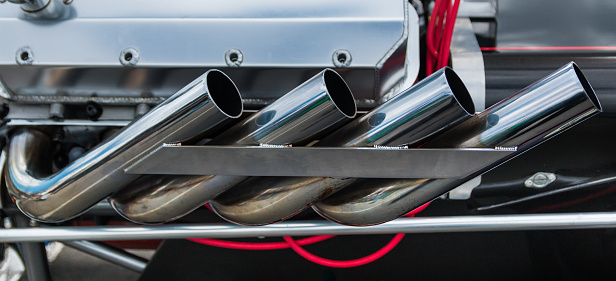 Dragster exhaust system looking very new and shiny.