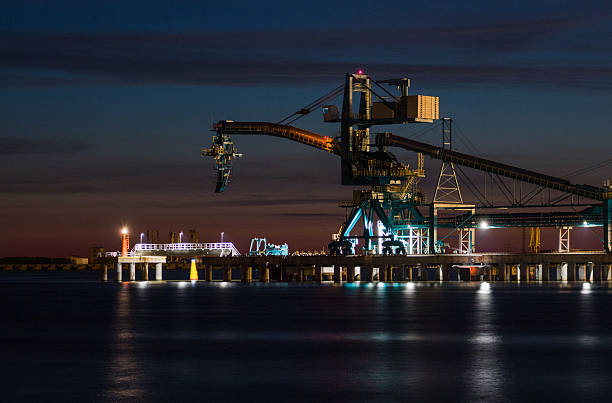 istock Bulk coal vessel loading machine at night in sea port 497196725