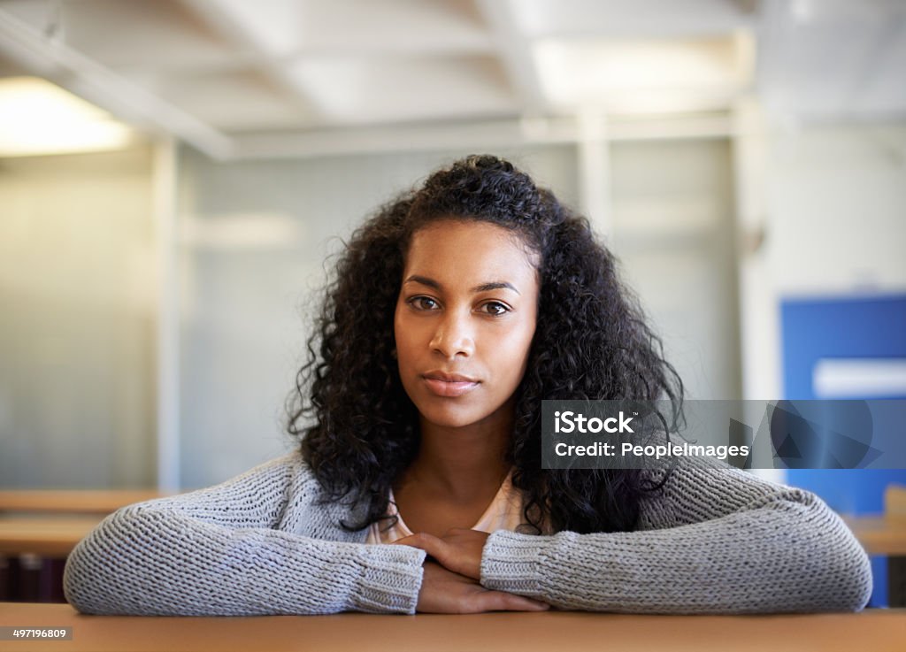 Studying is serious business Shot of a young female student sitting in a university library African Ethnicity Stock Photo