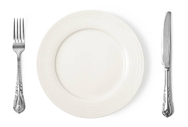 istock Vintage plate, knife and fork on white background 497197175