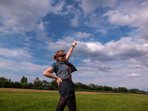 istock Female 35 years blue sky green meadow jeans 497198741