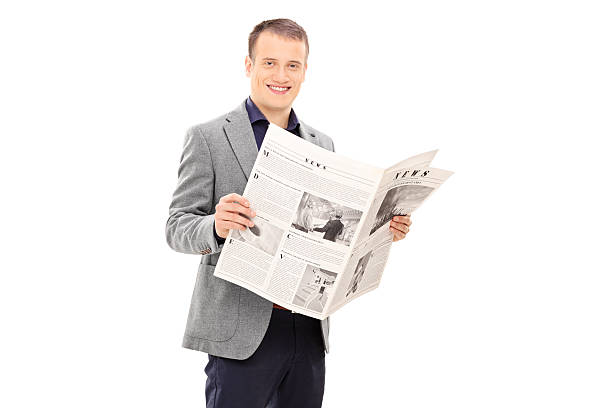 istock Elegant young man reading a newspaper 497199743