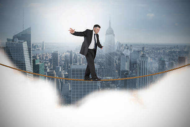 istock Composite image of mature businessman doing a balancing act 497201009
