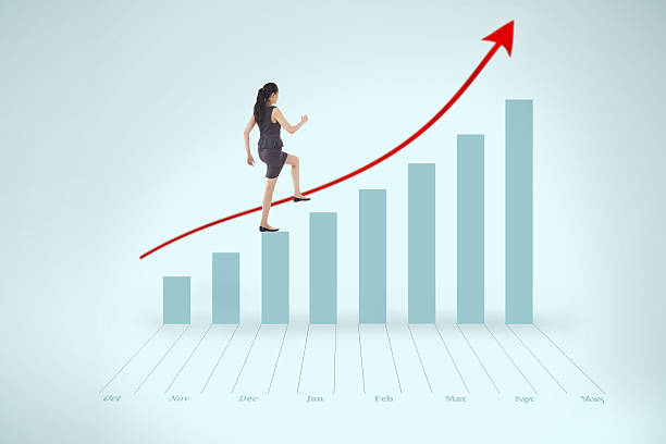 Businesswoman stepping up blue bar chart with red arrow