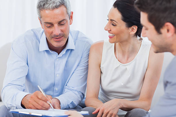 istock Client signing a contract with wife 497202391