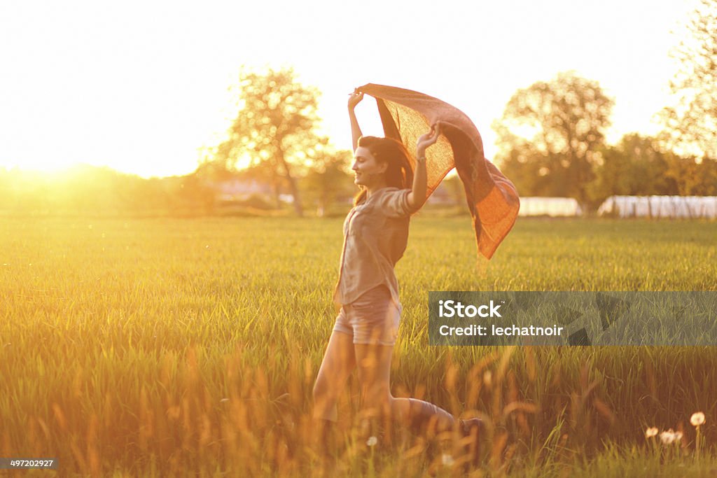 summertime happiness vintage toned image of a young woman enjoying the summertime. Only Women Stock Photo