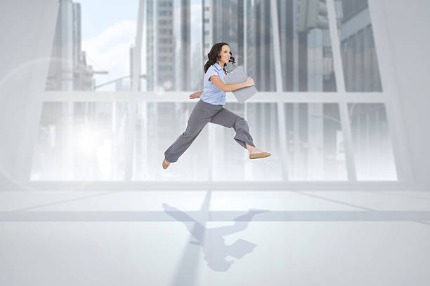 istock Composite image of cheerful classy businesswoman jumping while h 497203965