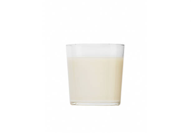 istock Glass of milk isolated on white 497208755