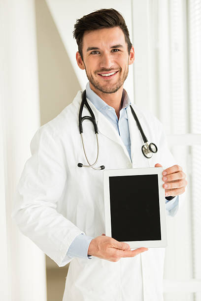 istock Male doctor with digital tablet 497208923