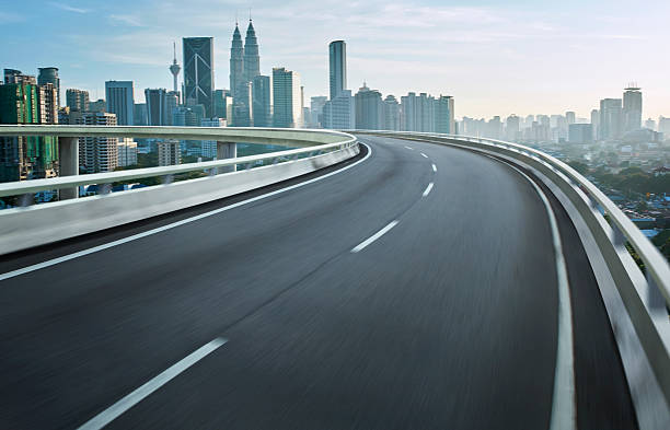 istock Highway overpass motion blur with city background . 497210488