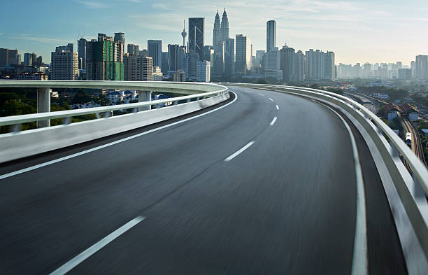 istock Highway overpass motion blur with city background . 497210568