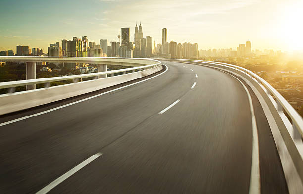 istock Highway overpass motion blur with city background . 497210630
