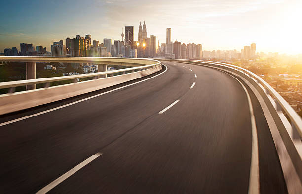 istock Highway overpass motion blur with city background . 497210674