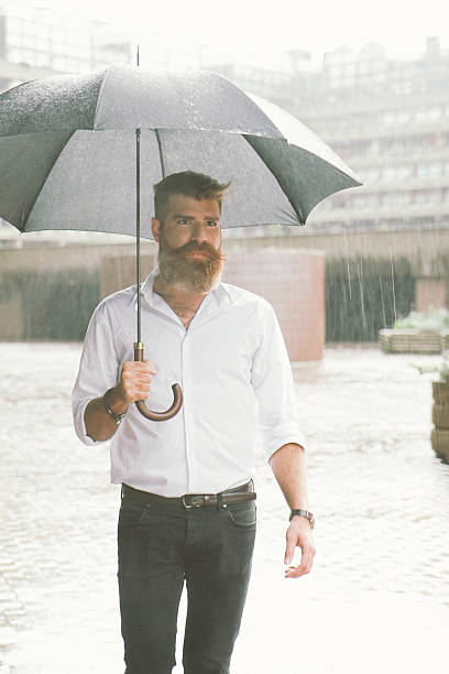 istock Businessman With Umbrella In The Rain 497211236