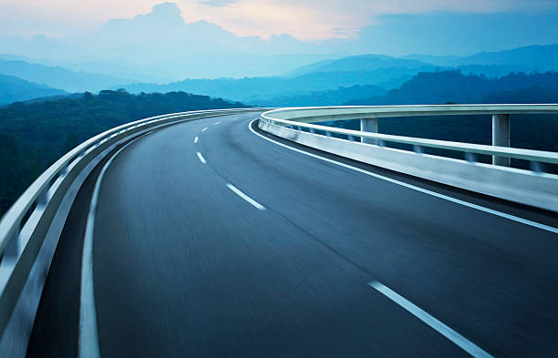 istock Highway overpass motion blur with coast skyline background . 497211956