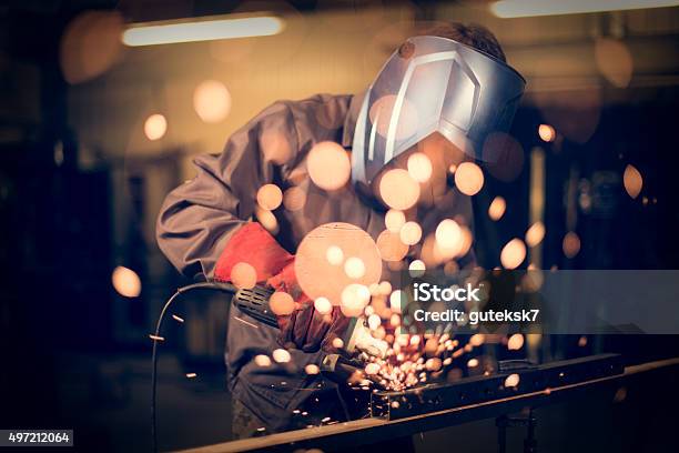 Employee Grinding Steel With Sparks Stock Photo - Download Image Now - Welding, Mechanic, Electricity