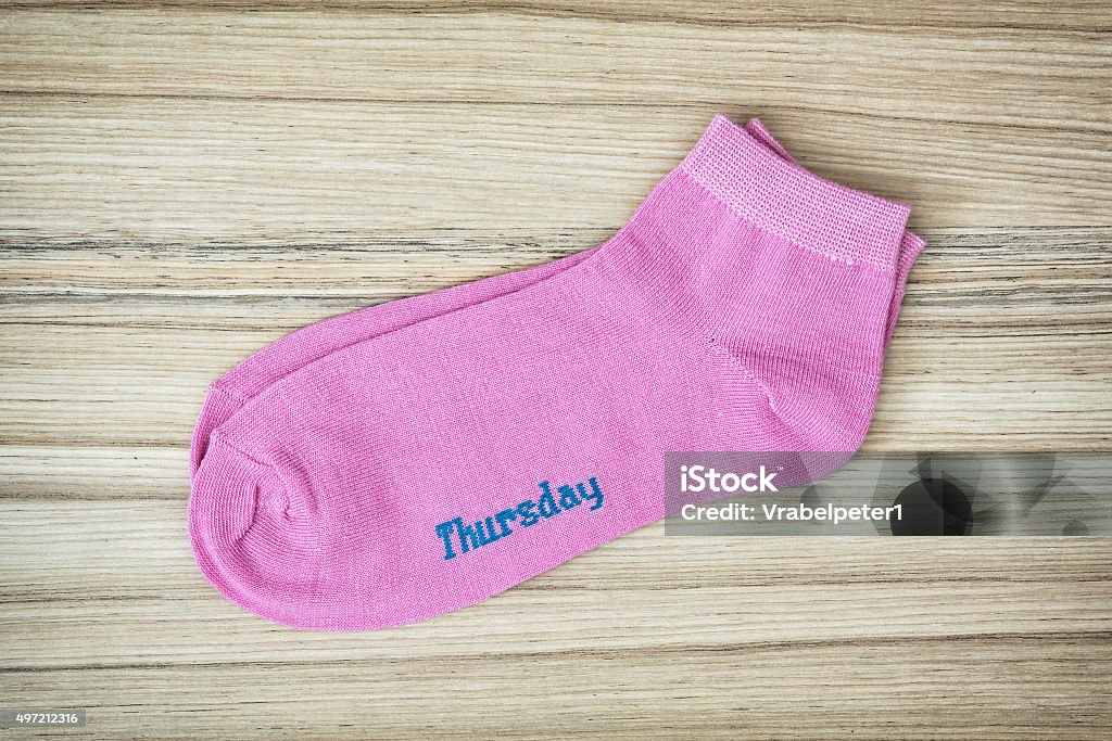 Trendy wool socks with inscription THURSDAY Trendy wool socks with inscription THURSDAY on the wooden background. 2015 Stock Photo