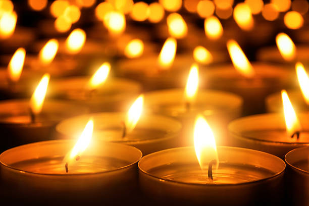 Candles glowing in the dark Many candle flames glowing in the dark, create a spiritual atmosphere flame photos stock pictures, royalty-free photos & images
