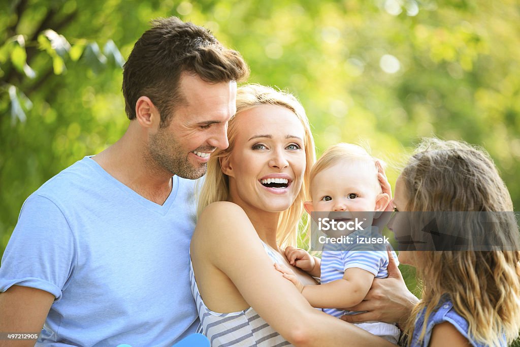 Happy family Outdoor portrait of happy parents with their children.  6-11 Months Stock Photo
