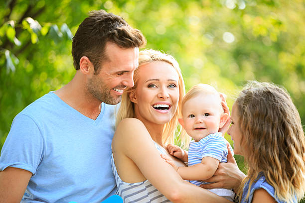 Happy family Outdoor portrait of happy parents with their children.  teenager couple child blond hair stock pictures, royalty-free photos & images