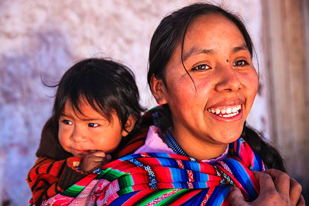 istock Peruvian woman with her baby on the back, Pisac 497213281