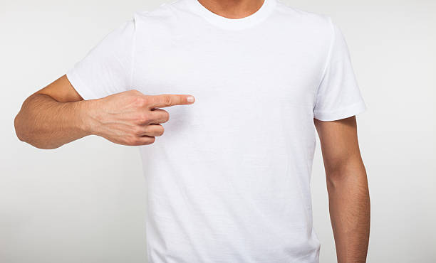 istock Man pointing his fingers on a blank t-shirt 497213409