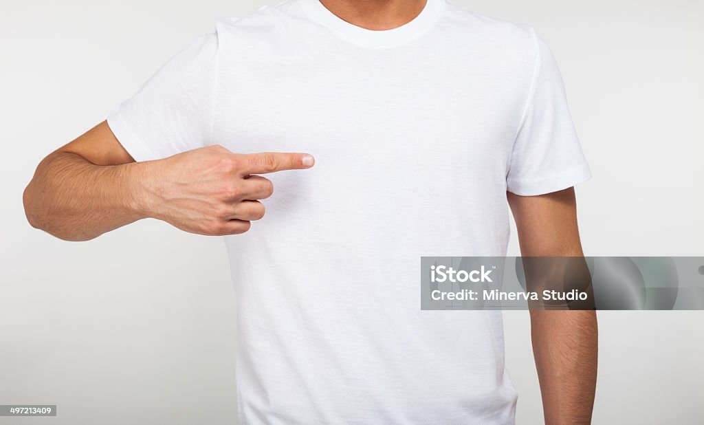 Man pointing his fingers on a blank t-shirt Close-up of a man pointing his finger on a blank t-shirt Adult Stock Photo