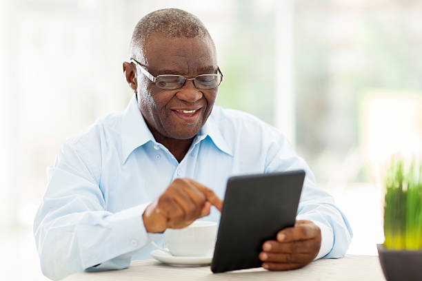 senior african american man using tablet computer at home