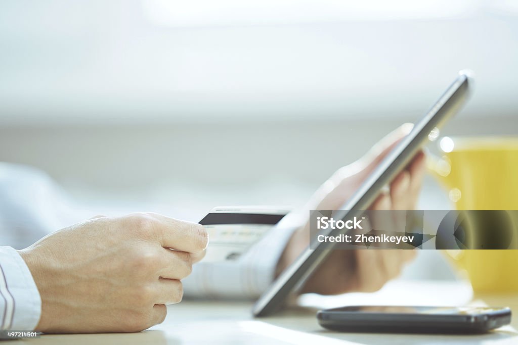 Online banking Human hands with tablet PC and credit card during lunch Adult Stock Photo