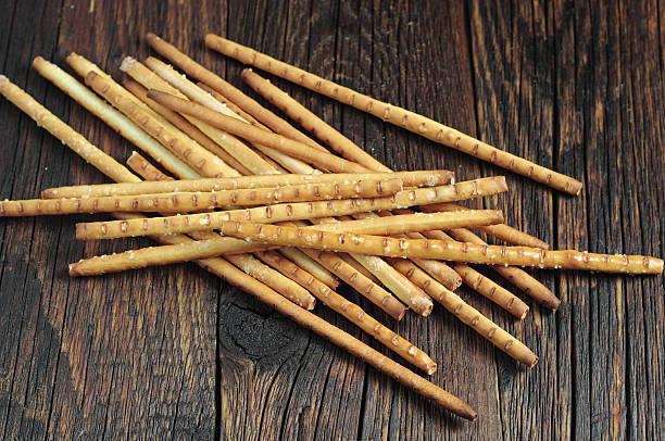 Heap bread sticks Heap salty bread sticks on dark wooden table biscuit quick bread photos stock pictures, royalty-free photos & images