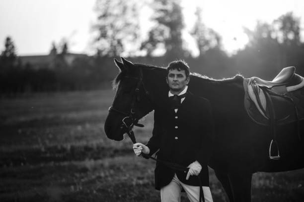 istock Man standing with horse on meadow 497214840