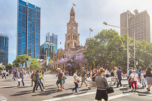 Sunny day in Sydney People walking in George St on a sunny day with the Sydney Town Hall building in the background. sydney stock pictures, royalty-free photos & images