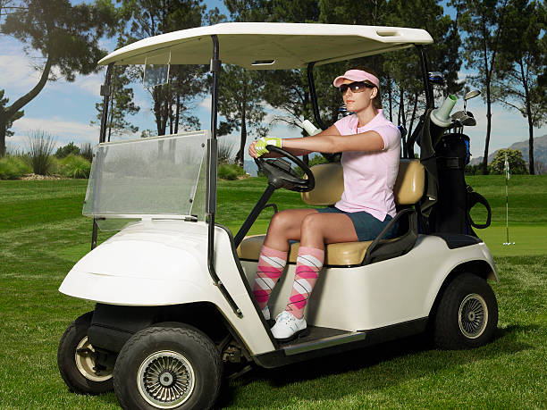 istock Woman Driving Golf Cart 497214953
