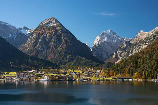 Pertisau at lake Achensee before the autumnal coloured forests and mountains of the Karwendel range