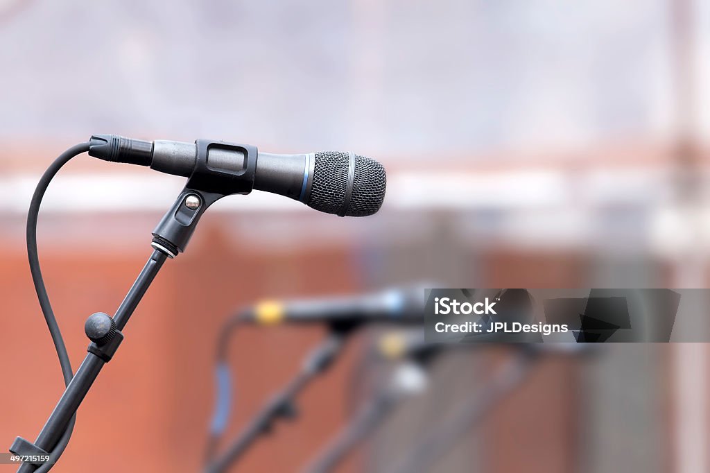 Row of Microphones for Backup Singers Row of Microphones for Backup Singer on Stage for Live Concert Performance with One Mic in Focus and Others in Blurred Background Close-up Stock Photo