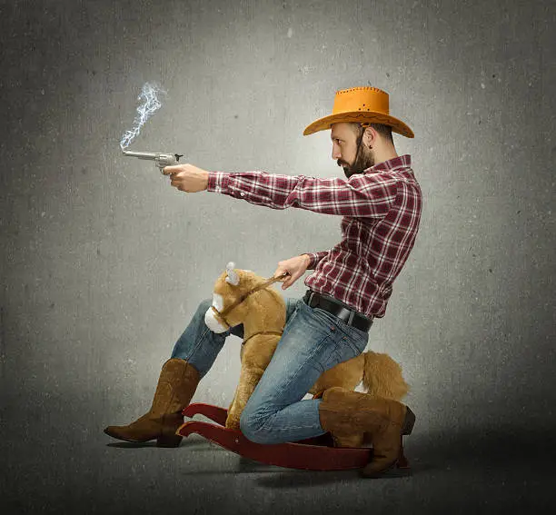 cow boy with gun in a fake rodeo