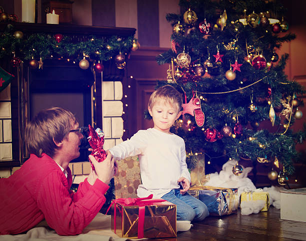 istock father and son giving presents at Christmas 497216452