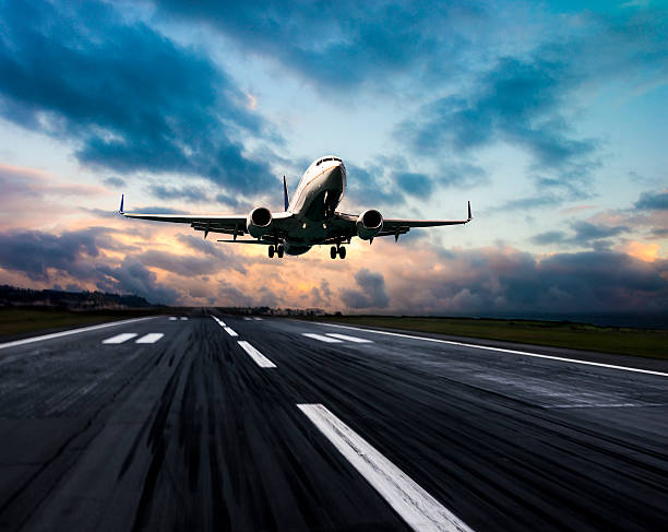 istock Passenger airplane landing at dusk 497218308