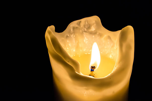 istock Candle flame at night isolated on black background 497220030
