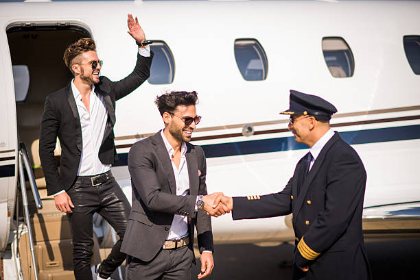 istock Famous men leaving private jet airplane 497221816