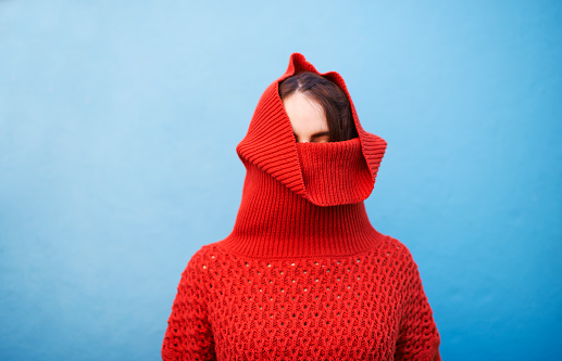 Shot of a young woman pulling her sweater over her headhttp://195.154.178.81/DATA/i_collage/pu/shoots/805920.jpg