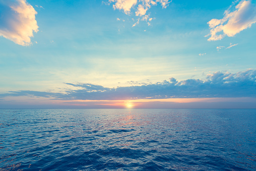 Sunset sky over the calm surface of the sea. 