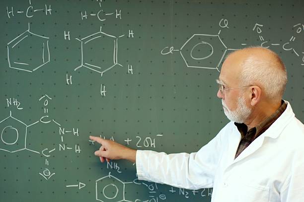 istock Teacher in front of his class at the blackboard 497227027